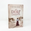 Buchcover und Innenansicht für das Buch: Die Dorflehrerin